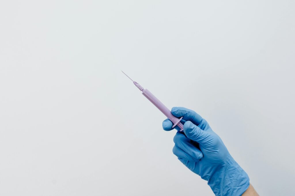 close up shot of a hand holding a syringe